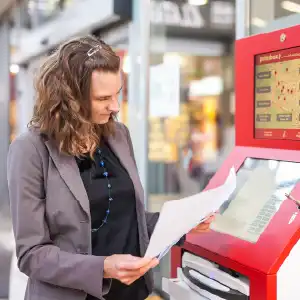 Printbox client looking at hers printouts at premium location - Supernova Mercator Šiška